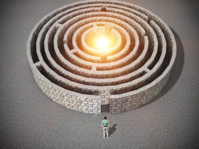 man stands in front of the entrance to the maze